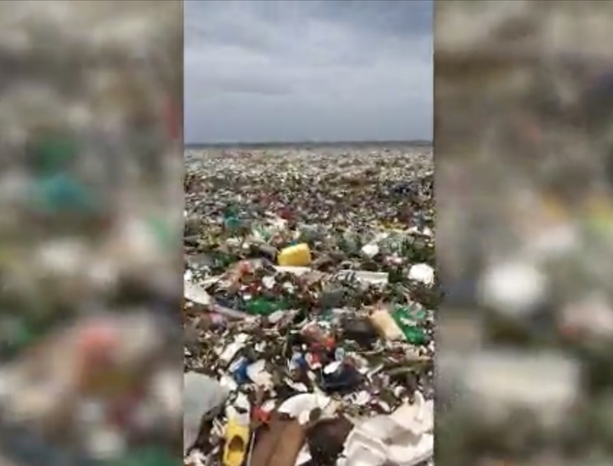Beach in Dominican Republic covered in garbage, plastic waste
